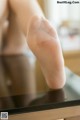 A close up of a woman's feet on a table.